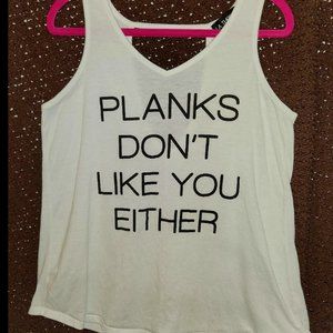 2 Tank Workout Shirts One is M and the other XL but they look the same size